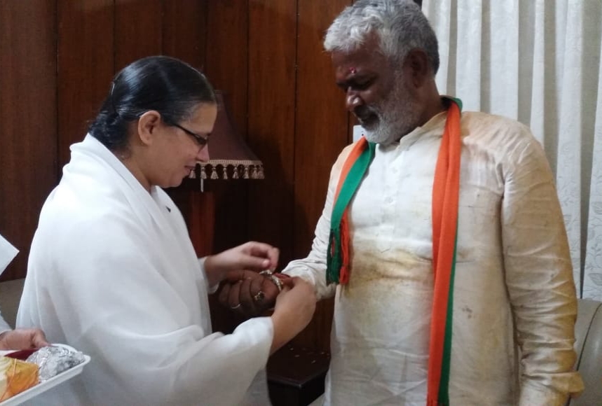 Tying Rakhi to B.J.P. Pradesh Adhyaksh Swatantra Dev Ji